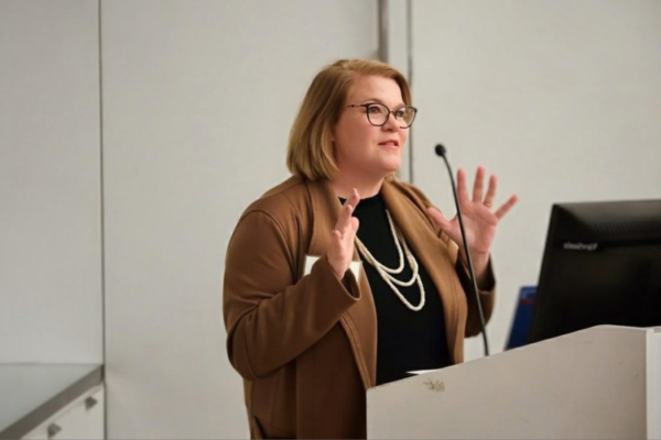 Nancy Drane speaking at podium